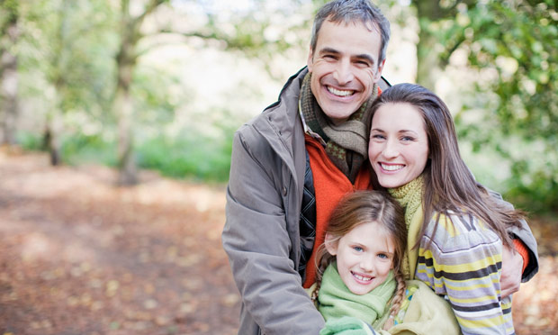 Smiling family hugging